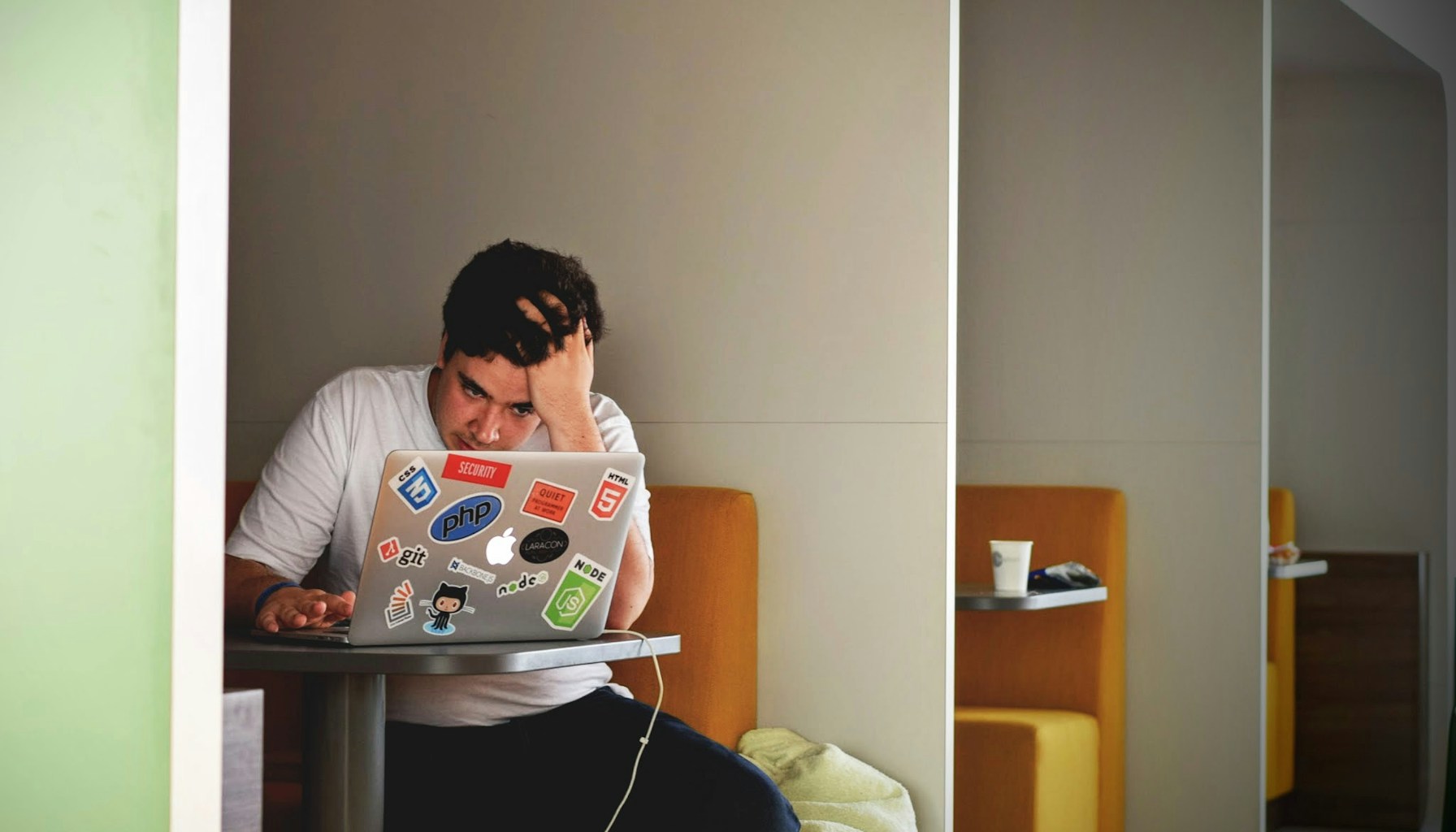 Student using a laptop and notebook while studying
